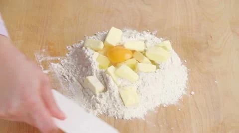 Chopping dough ingredients together using a scraper Stock Footage 24657236