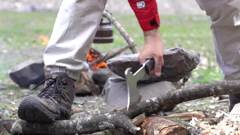 Chopping Firewood in Front of Campfire Stock Footage 303660611