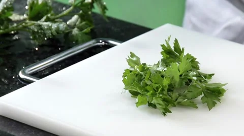 Chopping flat-leaf parsley Stock Footage 8573690