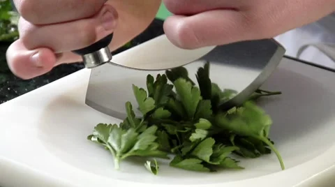 Chopping flat-leaf parsley Stock Footage 8573695