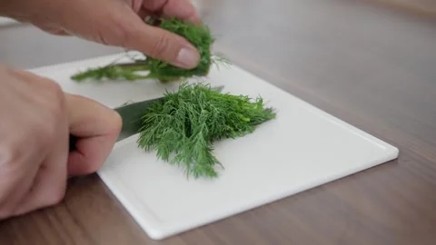 Chopping Fresh Dill for Culinary Use in Various Dishes, Enhancing Flavor and Video stock 314618997