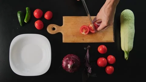 Chopping Fresh Tomatoes on Wooden Cutting Board Healthy Eating Top View with Video stock 315115053