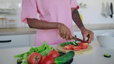 Chopping fresh vegetables in a modern kitchen setting is a vibrant and creative Stock Footage 284818546