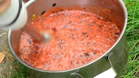 Chopping fruit with a blender in saucepan Stock Footage 69018732