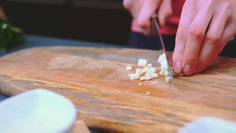 Chopping garlic on a cutting board Stock Footage 249407255