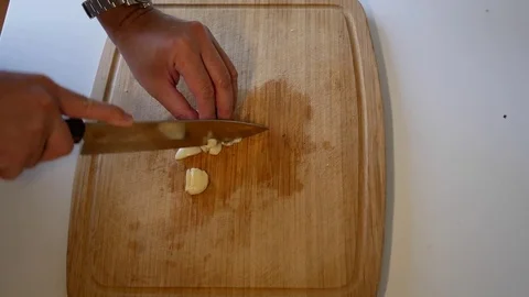Chopping Garlic with a kitchen knife Stock Footage 79285460