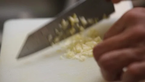 Chopping garlics on white board Stock Footage 97000474