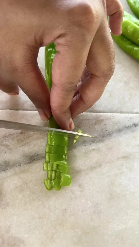 Chopping green chilli on a white stone board. Stock Footage 286215658