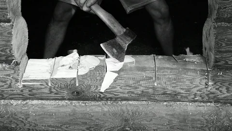 Chopping a log with an ax, making a threshold, black and white Stock Footage 117472569
