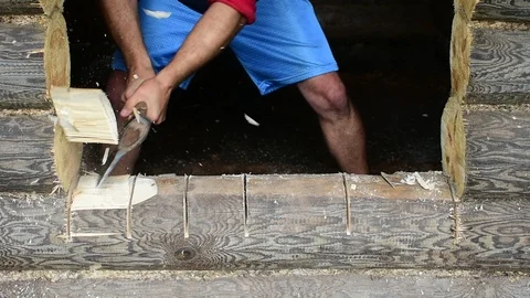 Chopping a log with an ax, making a threshold Stock Footage 117472727