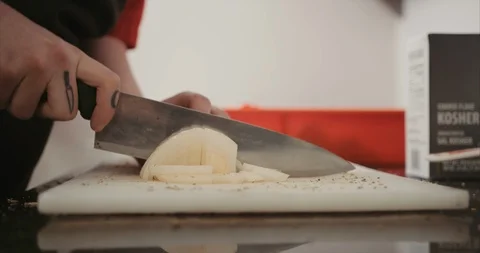 Chopping onion in the back of industrial kitchen Stock Footage 105297600