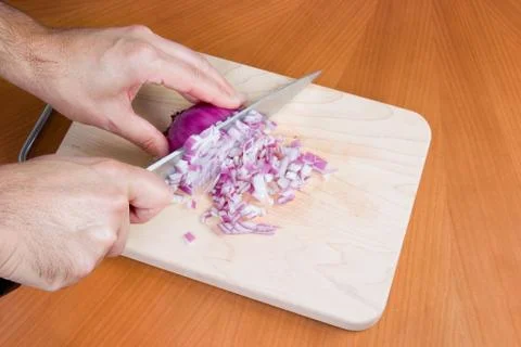 Chopping an onion on board Stock Photos