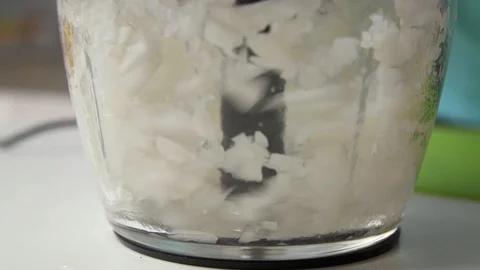 Chopping onion in food processor close up Stock Footage 122516577