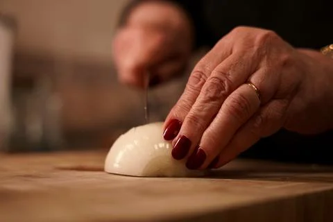 Chopping onion with knife. Stock Photos