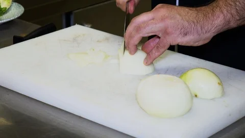 Chopping onion at a restaurant kitchen Stock-Footage 98457721