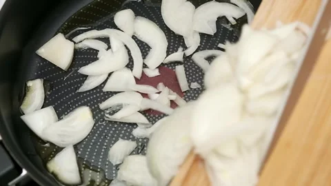 Chopping onions: culinary precision in professional kitchen setting Stock Footage 317579231