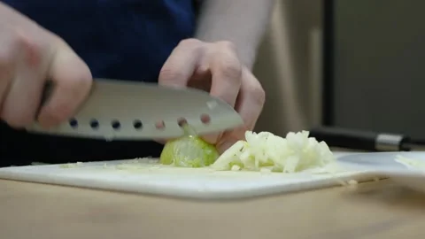 Chopping Onions in the Kitchen on Board Video stock 323656487