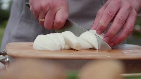 Chopping onions into large slices Stock Footage 228353814