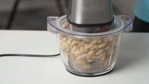 Chopping peanuts - peanut butter making process at home Stock Footage 122516646