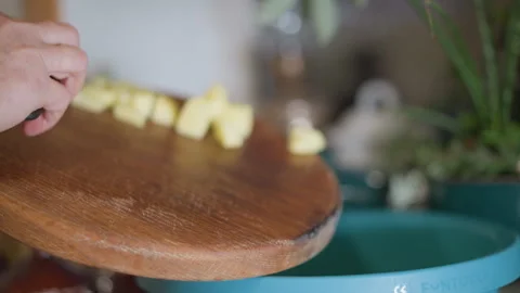 Chopping pineapple cubes on rustic kitchen counter. Detailed view of pineapple Stock Footage 346401103