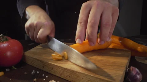 Chopping raw carrot on the wooden board cutting vegetables Stock Footage 143781053