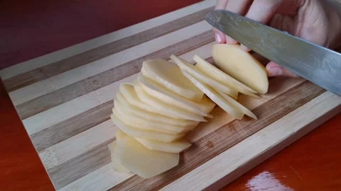 Chopping Raw Potatoes into Thin Slices Stock Footage 241511427