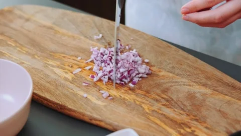 Chopping red onion on the kitchen Stock Footage 252180544