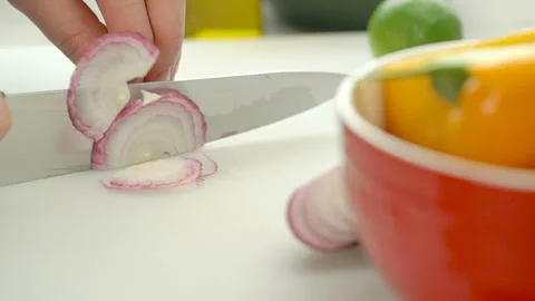 Chopping red onion on the white cutting board Stock Footage 88485445