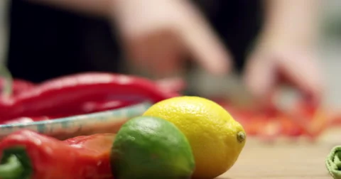 Chopping red pepper out of focus with lemon and lime in focus Stock-Footage 61535042