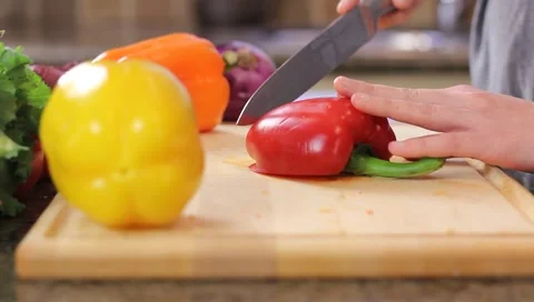 Chopping red peppers for dinner Stock Footage 4279997