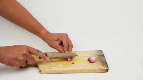 Chopping Red Shallots on a Cutting Board Stock Footage 327852408