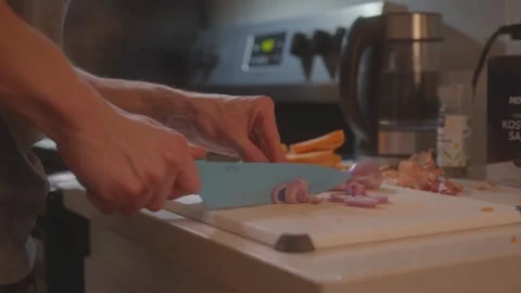 Chopping shallots on cutting board -Sweet Potato Saffron Risotto (Clip 19 Stock Footage 243082842