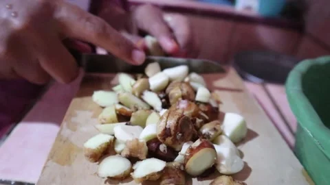 Chopping spices or herbs with a knife on a cutting board. Stock Footage 303200836