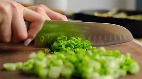 Chopping spring onion. Chef hand cutting raw green onion with knife, chopped Stock Footage 245258020