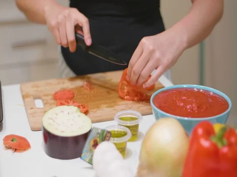 Chopping a tomato in slow motion Stock Footage