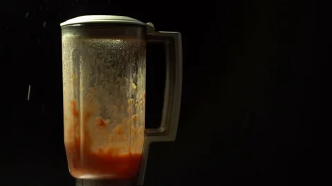 Chopping tomatoes in a blender on a black background, slow motion Stock Footage 79934965