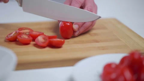 Chopping tomatoes on cutting board Stock Footage 245800017