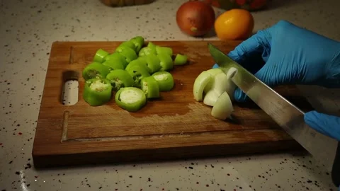 Chopping vegetables such as a onion, pepper and lemon Stock Footage 148043147