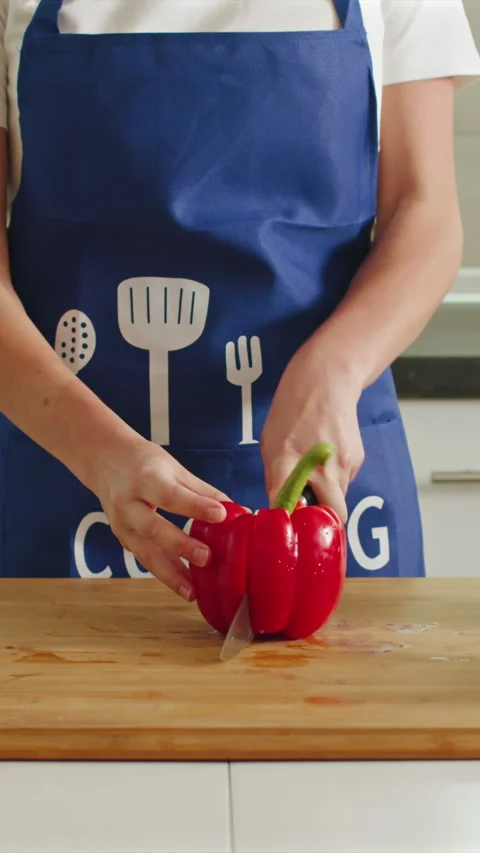 Chopping vibrant bell peppers with skill in a cozy kitchen Stock Footage 341762005