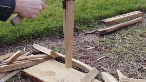 Chopping wood into chips to light a fire with an ax Stock Footage 148019793