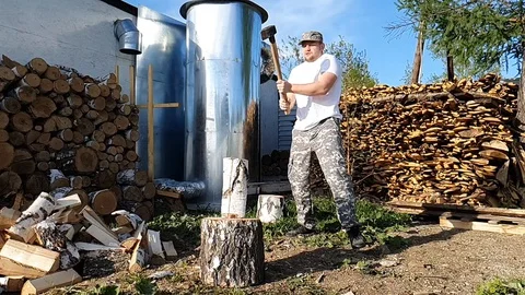 Chopping wood slow motion. Worker chopping wood outdoors Stock Footage 129959968