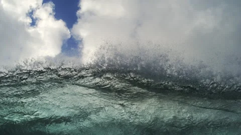 Choppy Ocean Swell Rolling Below Towering Clouds and Blue Sky Stock Footage 344378436