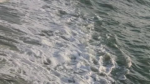 Choppy ocean waves creating white foam with dark sea water contrast Stock Footage 322096095