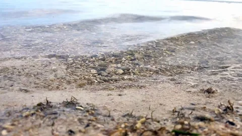 Choppy water breaks gently on sandy beach Stock Footage 116730989