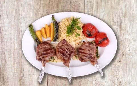 Chops in white plate Stock Photos