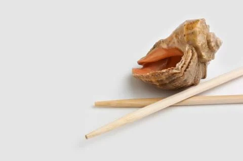 Chopsticks and shells Stock Photos