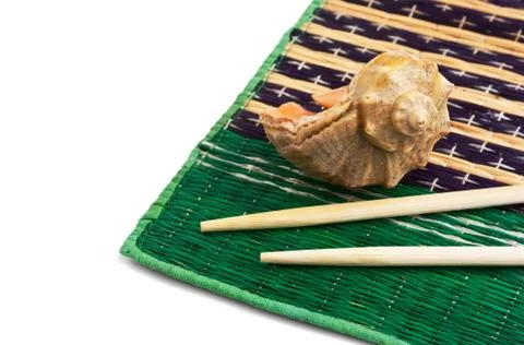 Chopsticks and shells Stock Photos