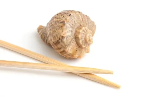 Chopsticks and shells Stock Photos