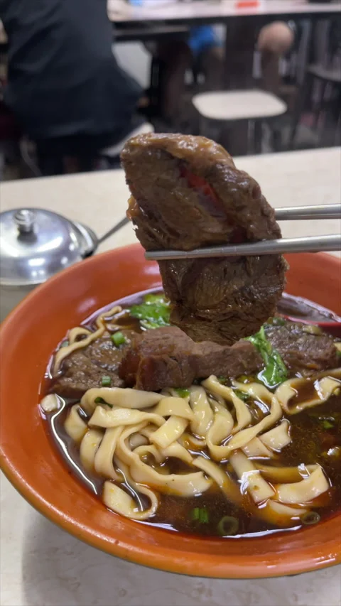 Chopsticks Lifting Braised Beef From Noodle Soup At Taipei Night Market Stock Footage 342838665