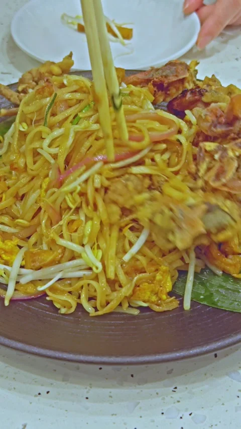 Chopsticks Lifting Noodles from Soft Shell Crab Pad Thai Stock Footage 314985161